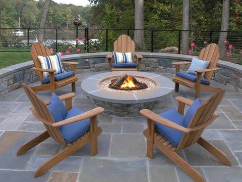 Gas fire pit coffee table anchoring a backyard lounge seating arrangement