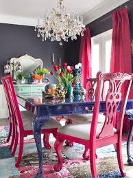 A Bold Blue Dining Table Hot Pink Chairs And A Crystal Chandelier For A Vibrant Space Pink Dining Rooms Pink Dining Chairs Dining Room Design