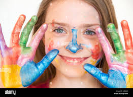 Portrait of smiling girl with finger paints