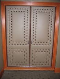 These Upholstered Doors Are Executed With Precision Detailing Using Pewter Nailheads And Tacks Farmhouse Upholstery Fabric Upholstery Trends Modern Upholstery