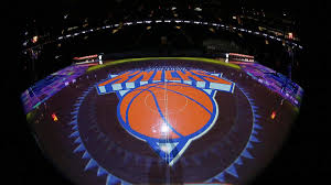 Knicks in orange and blue above orange basketball on grey triangle. Leon Rose Led Knicks Will Be Rewarded For Rare Patience In Rebuilding Effort Cbssports Com