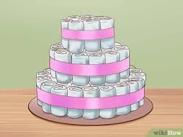 Place a heavy bottle of baby lotion or shampoo in the center of your cake base. 3 Ways To Make A Diaper Cake Wikihow