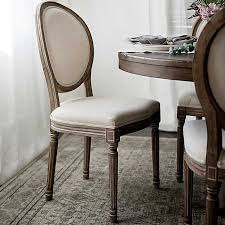 This pretty chair features velvety smooth upholstery on its back and seat cushions to comfort and pamper guests while they enjoy their meals. Ivory Louis Dining Chair Kirklands