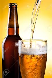 Beer Being Poured In Glass And Bottle On Yellow Background Stock Photo Picture And Royalty Free Image Image 13855573