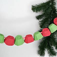 A christmas tree with amazing red and white ornaments and gold letters plus printed and bold gift boxes stacked under the tree. Christmas Garland Easy Preschool Craft Preschool Toolkit
