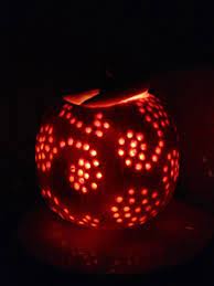 my pumpkin i carved first i made a design with black sharpie next i used a drill to carve the little holes in aft pumpkin drilling pumpkin carving carving