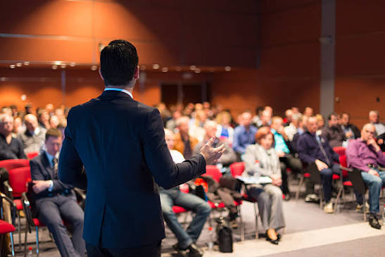 Speaker presenting confidently to a live room