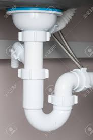 water pipes under sink closeup stock