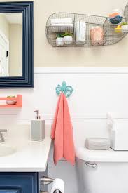 A blank wall gets a pretty and useful makeover with the addition of beadboard, wall art and hooks. One Day Makeover Staging A Kid S Bathroom To Sell In Just 8 Hours For Under 200 T Moore Home Interior Design Studio