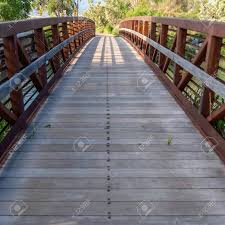 Decks may be made from dozens of different kinds and types of woods live loads are portable while dead loads are permanent. Square Bridge With Wood Deck And Rusty Metal Railing Over A Lake Stock Photo Picture And Royalty Free Image Image 127978406