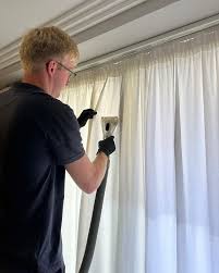 Erith installer measuring a window before blind installation