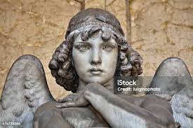 White Marble Angel Looks Out From Dusty Alcove Stock Photo