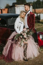 A burgundy suit with black lapels for the groom and a black wedding dress for the bride. Rock Wedding Shoot In Pink Burgundy And Black Weddingomania