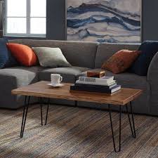 This coffee table's top is plated in real, textured brass. Tindle Live Edge Hairpin Coffee Table Wayfair Havenly