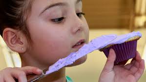 Children show off cupcake-decorating skills