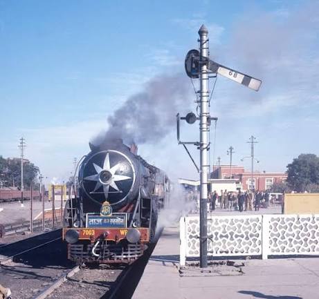 Udyaan Abha Toofan Express showing its full glory from steam era. Pacific class WP, departure Agra 1975 (WS)