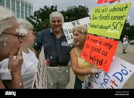 Velaine Simmons, of Walhalla, S.C., right, talks with Gov. Sanford  supporters, John Perna, center, and Sharon Clark, second from left, both of  Columbia, during a rally calling for South Carolina Gov. Mark