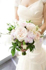 A textural boho wedding bouquet with pastel blooms, greenery, dried leaves and spikes plus feathers for a boho bride. Pastel Wedding Bouquet