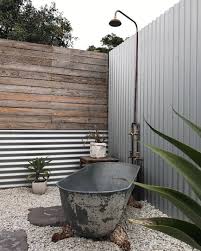 Stone Timber Iron And Copper Makes For A Quality Outdoor Bathroom Shower Bath Combination For Good Outdoor Bathroom Design Outdoor Bathrooms Outdoor Bathtub