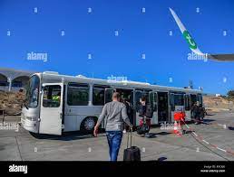 Santorini, Greece - Oct 8, 2018. Passengers taking the shuttle bus at  Santorini Airport (JTR Stock Photo - Alamy