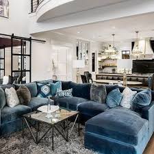 The navy curved sofa, pink chair and purple barstools are all clad in velvet, giving the space an abundance of texture. Blue Velvet Sectional With Blue Chaise Lounge Blue Living Room Living Room Sectional Home Living Room