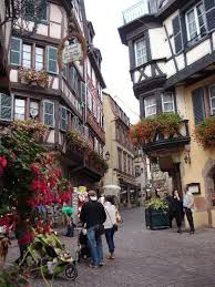 Half Timbered Houses Along A Shopping Street In Old Colmar European Tour Places To See Places To Go