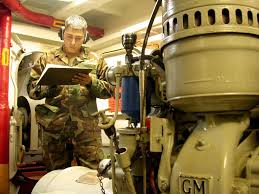 Engineman 2nd Class Richard Padilla from Poston, Ariz., verifies that the  oil temperature