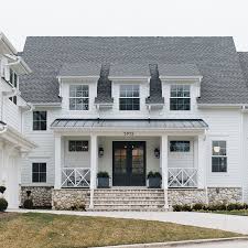 The interior is equally impressive, with an open floor plan that accommodates today's family and modern lifestyles. Modern White Farmhouse With Stone Foundation Modern Farmhouse Exterior Farmhouse Exterior Timber Trail