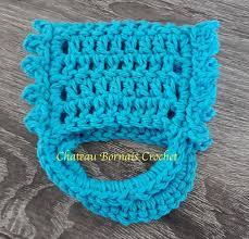 This pattern was designed by naztazia. Do You Find Yourself Picking Up Your Kitchen Towel Everyday Because It Has Slipped Off Of The Stove H Crochet Towel Crochet Towel Topper Crochet Towel Holders