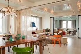 These sheer white patterned curtains look great against the sunny yellow walls in this eclectic dining room design. 4 Quick Ways To Update Your Home S Decor For Summer Curtains Living Room Modern Modern Room Divider Elegant Dining Room