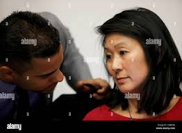 Alex Randolph (left), board president, talks to Ivy Lee, trustee, during  the Board of Trustees meeting in Conlan Hall at City College San Francisco  in San Francisco, Calif.,