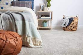 Weathered gray oak flooring extends up the wall and overhead to create a captivating treatment. Inexpensive Bedroom Flooring Ideas