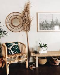 A Boho Desert Entryway With Rattan Furniture Cacti Artworks Potted Plants And Grasses Minimalist Decor Decor Boho Chic Entryway