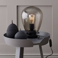 The smoked glass base features a subtle bubble detail, perfectly complemented by the chrome detailing and luxurious grey velvet shade. Belid Dolores Table Lamp With Black Metalwork And Smoked Glass