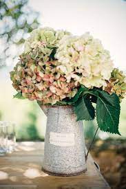 8 Chic Summer Wedding Flowers Mywedding Water Wedding Centerpieces Flower Centerpieces Wedding Watering Can Centerpieces