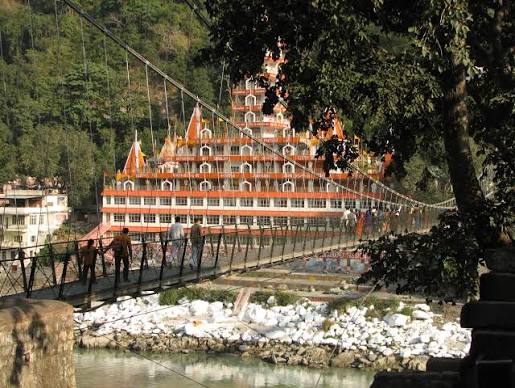 Iron suspension bridge crossing the Ganges with pilgrims and vendors
