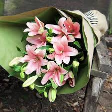 Flower in vase near wall. Tiger Lily Love Bouquet Flowers For Everyone