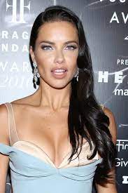 Take a look on her skinny body style. Adriana Lima Wavy Black Long Layers Side Part Hairstyle Steal Her Style