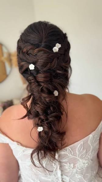 This half up half down combines romantic waves with intricate fishtail braids. I joined the fishtail braids at the back of the head to create a twisted section, creating a soft focal