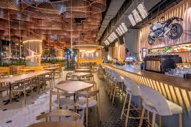 Walk into an industrial style space where a lot of concrete, rugged wood and brick walls painted in white are found in a dimmed lit space… it's an american style diner where the kitchen and bar welcome you with open arms. Vivo Fusion Food Bar