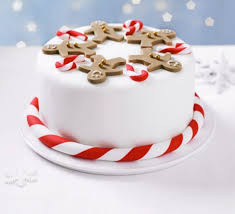 Carefully flip the parchment and fondant onto the cake; Gingerbread Man Party Cake Recipe Bbc Good Food