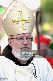 Bishop Sean Patrick O'Malley is greeted by Msgr. Stephen J. Avila,... News  Photo