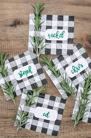 A miniature tree, snowman, gumdrop animal and a folded paper place card. Easy Diy Place Cards For Christmas Joyful Derivatives