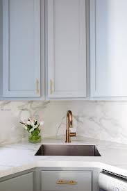 Small Gray Kitchen With A Corner Sink And A Brass Faucet Finished With Gray Cabinets And A Marb Kitchen Remodel Small Corner Sink Kitchen Small Marble Kitchens