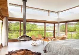 The room has hardwood floors and a sliding glass window. 20 Contemporary Bedrooms With A Beautiful Outdoor View From Glass Windows Home Design Lover