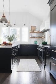 Black kitchen cabinets with white marble countertops. White Range Hood With Black Cabinets Cottage Kitchen