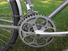 The restrictions referred to is the distance one revolution of the crank arm will propel the bicycle, this is known as the 'roll out'. Bicycle Gearing Wikipedia