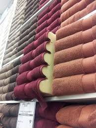 If you're looking into not just hanging towels but also organizing bathroom essentials, getting a rack with integrated shelves is ideal. Bed Bath Beyond S Stack Of Towels Is A Damned Lie Neatorama