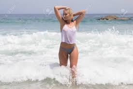 A Sexy Blonde Woman Swimming In The Ocean In Her Bikini And A Wet See- through Shirt Stock Photo, Picture and Royalty Free Image. Image 59966554.