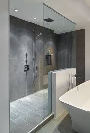 Large Walk In Doorless Shower With Gray Slate Tiles And A Floating Glass Wall Creates A Gorgeous Modern Look Bathroom Remodel Shower Shower Remodel Shower Tile